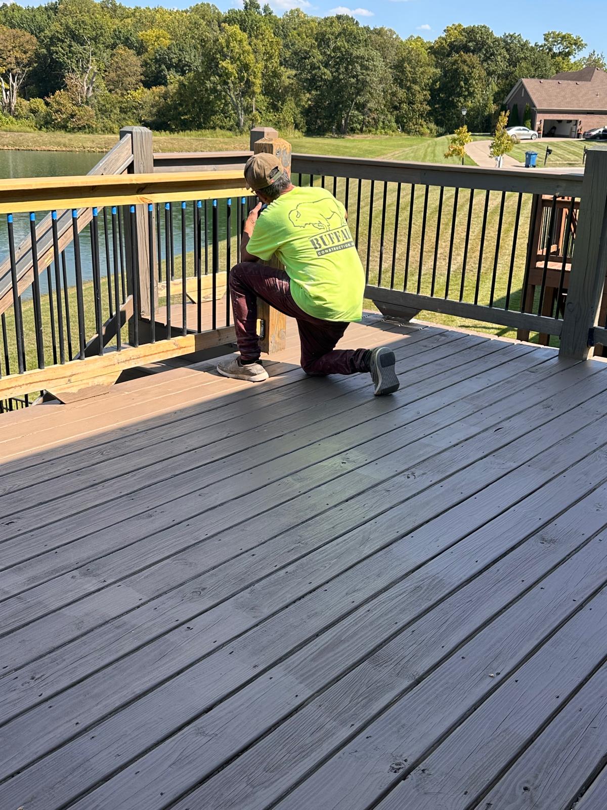 Crew member finishing deck railing work